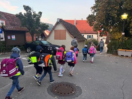 Kinder auf dem Schulweg von Eltern begleitet